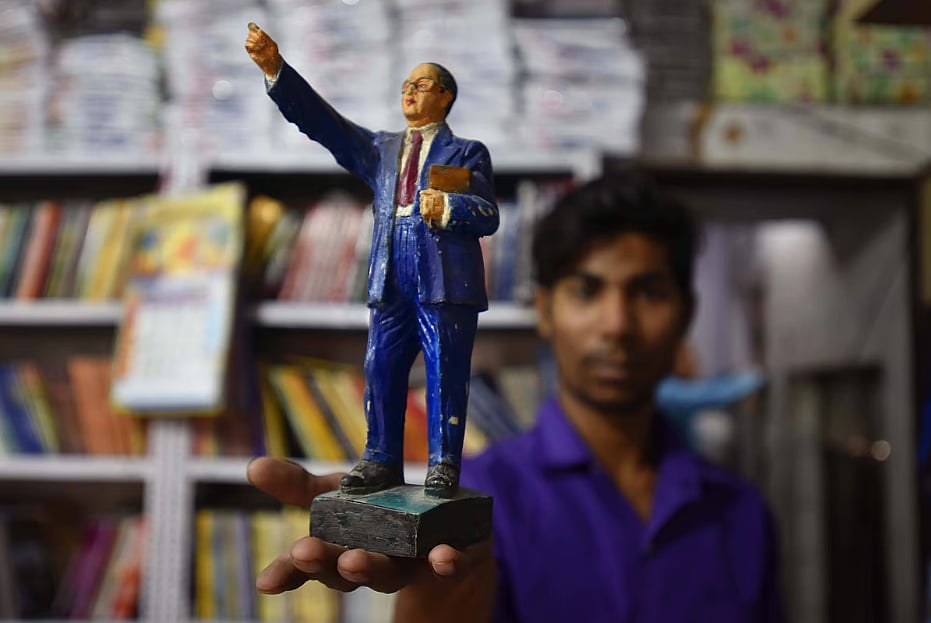 A shopkeeper in Delhi with a statuette of B R Ambedkar for sale. Six new books on Ambedkar examine his life and thought with sincere reverence as well as honest critique.