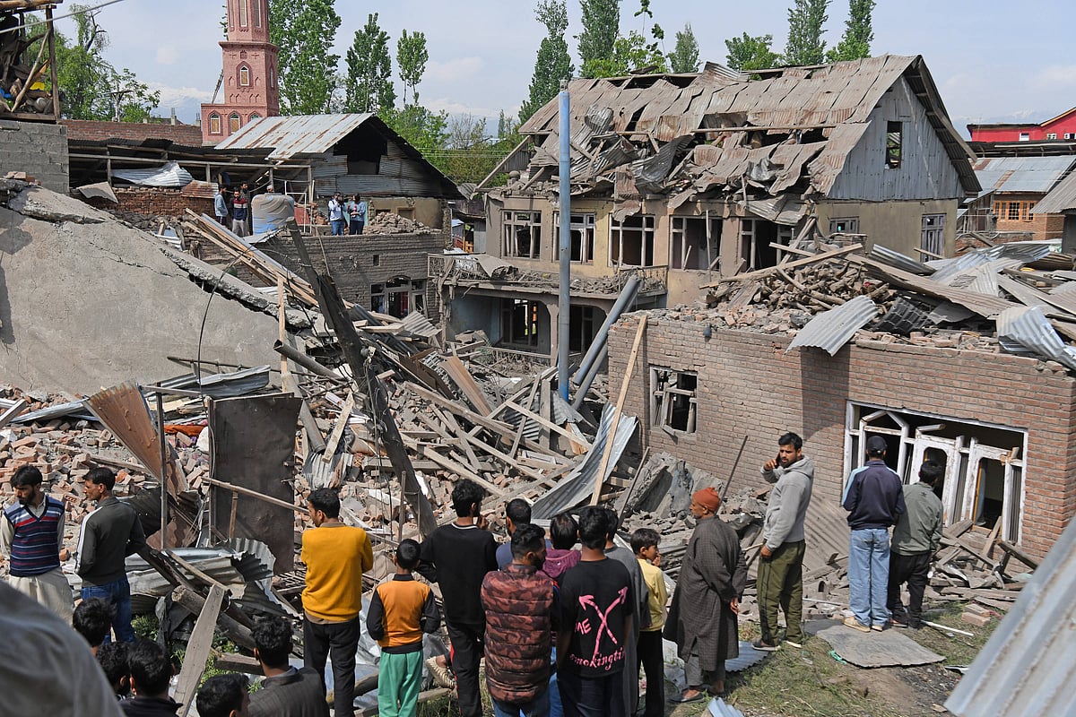 Villagers observe the blown-up family home of Ahsan Ul Haq Shiekh, accused of being involved in the Pahalgam attack. 