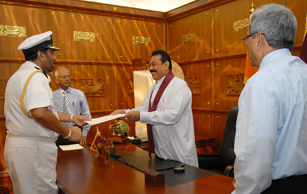 Photo of Mahinda Rajapaksa handing Sri Lanka navy chief Wasantha Karannagoda his appointment letter. Mahinda's brother Gotabaya Rajapaksa watches on