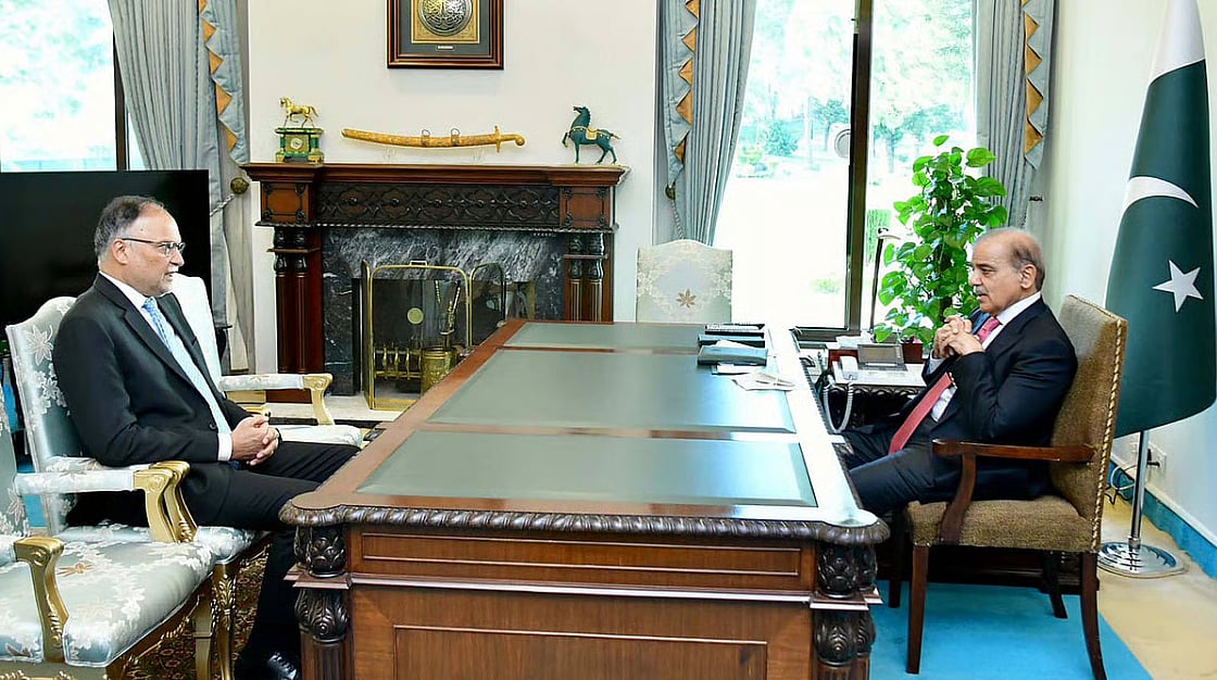 Pakistan’s prime minister, Shehbaz Sharif, with Ahsan Iqbal, the federal minister for planning and development.