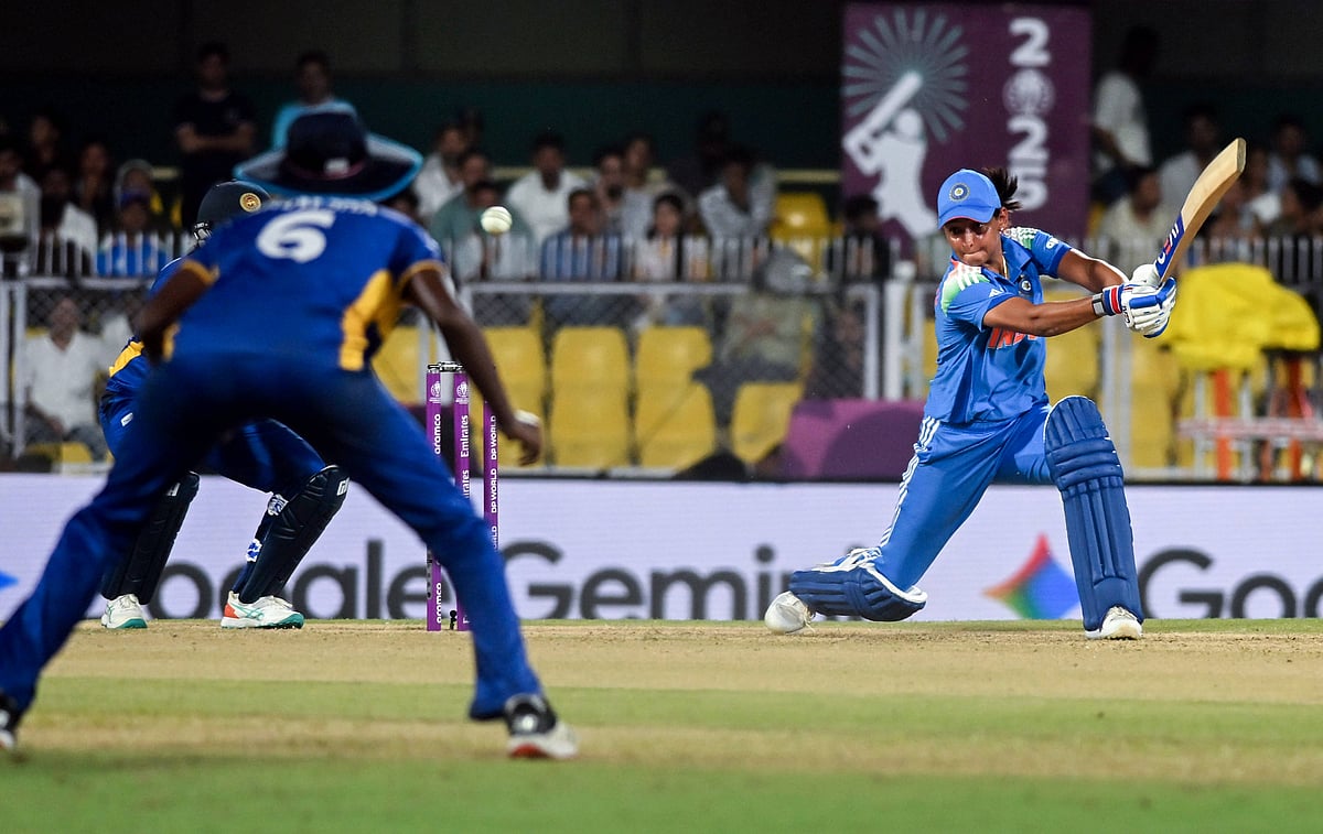 Photo of India women's cricket captain Harmanpreet Kaur batting as a Sri Lanka fielder looks on during ICC Women's Cricket Wo