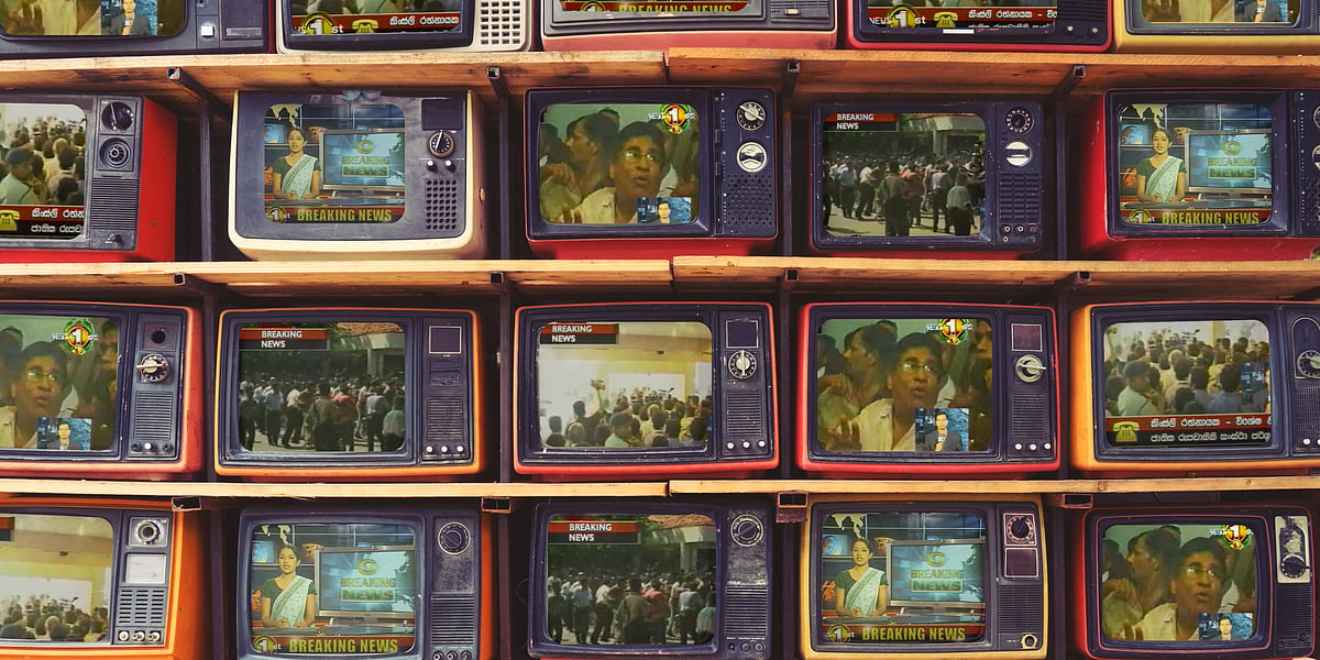 An illustration of TV screens stacked one on top of the other on wooden shelves. The screens are playing stills from Sri Lank