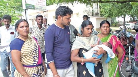 குழந்தையுடன் புகார் அளிக்க வந்த பெற்றோர்.