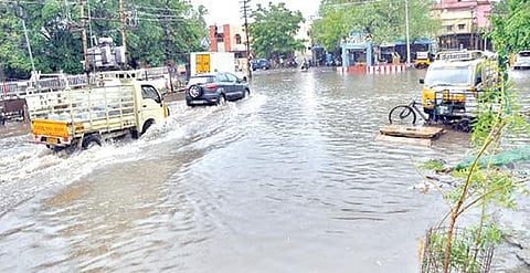 பாளையங்கோட்டை தலைமை தபால் அலுவலகம் முன் தேங்கிய தண்ணீரில் ஊர்ந்து சென்ற வாகனங்கள். 		              படம்: மு.லெட்சுமி அருண்