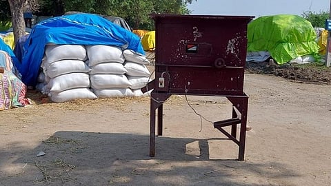 மானாமதுரை அருகே சின்னகண்ணனூரில் கூடுதல் நெல் கொள்முதல் நிலையம் திறக்காததால் பயன்பாடின்றி இருக்கும் தரம் பிரிக்கும் இயந்திரம்.