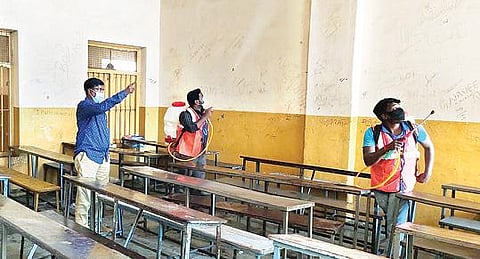 ஆம்பூரில் உள்ள அரசு நிதியுதவி பெறும் பள்ளியில் கிருமி நாசினி தெளிக்கும் பணியில் ஈடுபட்ட தூய்மைப்பணியாளர்கள்.