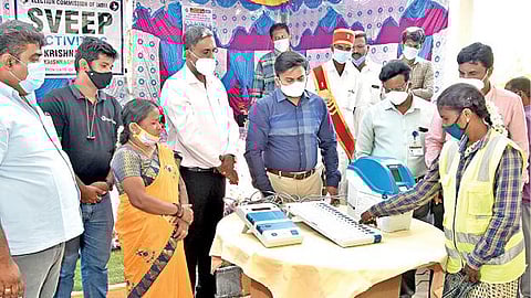 கிருஷ்ணகிரி அருகே குருபரப்பள்ளியில் உள்ள தனியார் கட்டுமான நிறுவனத்தில் நடந்த வாக்காளர் விழிப்புணர்வு நிகழ்ச்சியில் மாதிரி வாக்குப்பதிவை மாவட்ட வருவாய் அலுவலர் சதீஷ் பார்வையிட்டார்.