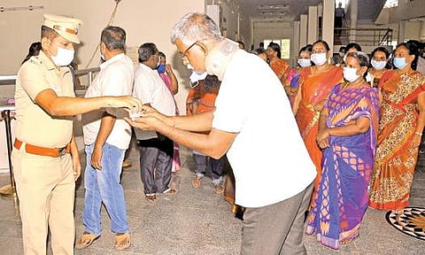 திருநெல்வேலி மாநகர காவல் ஆணையர் அலுவலகத்தில் பணியாற்றும் அமைச்சுப் பணியாளர்கள் மற்றும் காவலர்களுக்கு துணை ஆணையர் சீனிவாசன்  கபசுர குடிநீர் வழங்கினார். படம்: மு.லெட்சுமிஅருண்