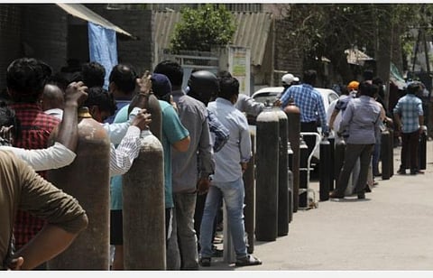 டெல்லியில் ஆக்சிஜன் வாங்க வரிசையில் நிற்கும் மக்கள் | படம்: பிடிஐ.