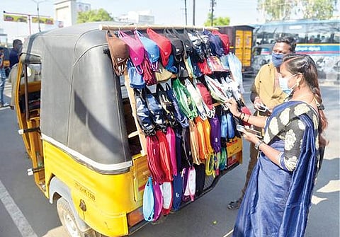 வேலூர் புதிய பேருந்து நிலையத்தில் ஆட்டோவை சிறு கடையாக மாற்றி முகக்கவசம் விற்பனை செய்யும் ஆட்டோ ஓட்டுநர் மணி. படம்:வி.எம்.மணிநாதன்.