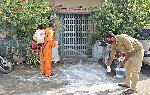 கரோனா தொற்றால் பாதிக்கப்பட்ட ஈரோடு கிருஷ்ணன்பாளையம் சித்தன் நகரில் கிருமி நாசினி மருந்து தெளிக்கும் மாநகராட்சி ஊழியர்கள்.