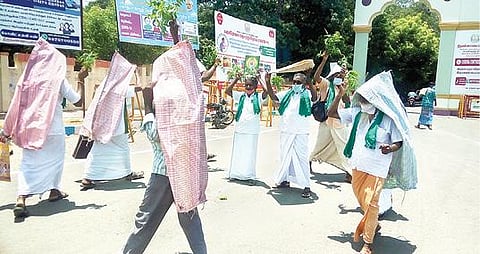 நேரடி நெல் கொள்முதல் நிலையம் திறக்கக்கோரி, திருவண்ணாமலை மாவட்ட ஆட்சியர் அலுவலகம் முன்பு கற்பூரம் ஏற்றி அம்மனை வழிபட்டு நூதன போராட்டத்தில் ஈடுபட்ட விவசாயிகள்.  படம்:இரா.தினேஷ்குமார்.