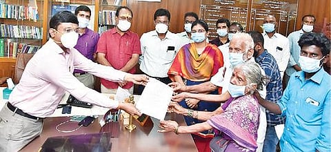 மேல்சோழங்குப்பம் கிராமத்தில் வசிக்கும் மாணிக்கத்திடம், நிலம் மீட்கப்பட்டு பட்டா மாற்றம் செய்யப்பட்டதற்கான ஆணையை வழங்கிய ஆட்சியர் பா.முருகேஷ்.