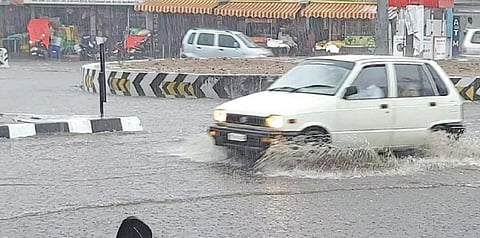 பொள்ளாச்சியில் நேற்று பெய்த கன மழையால், பல்லடம் சாலையில் தேங்கிய மழைநீரை பீய்ச்சியடித்தபடி சென்ற கார