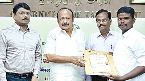 அமைச்சரிடம் இருந்து பாராட்டுச் சான்றிதழ் பெறும் சந்திரகுமார்.