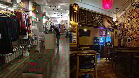 Exterior view of a Humayunpur storefront featuring a bustling local restaurant alongside a trendy boutique shop, reflecting the neighbourhood's vibrant mix of culinary delights and street-style