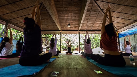 Image of women doing yoga during holistic retreat with Kyo Spaces