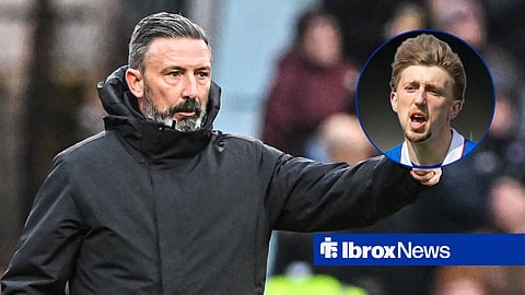 Derek McInnes holding his thumb up in the direction of Dan Neil, who is in action for Rangers at Ibrox.