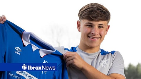 Kyle Glasgow holding up a Rangers jersey