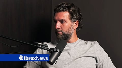 Charlie Mulgrew on podcast speaking into microphone