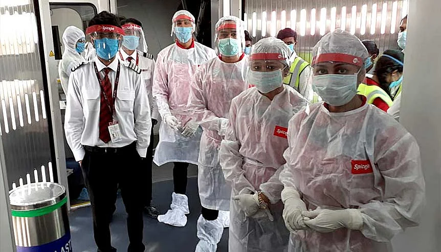 Spicejet flight attendants wearing PPE kits pose for a photo before departure. SpiceJet will be the first Indian low-cost carrier to connect Delhi and Mumbai with London Heathrow with non-stop flights.Credit: Getty Images