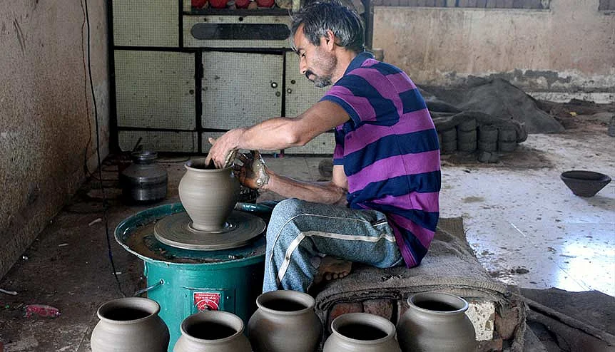 Just a glimpse of Gujarat's pioneering spirit. A potter making clay pot lamps in Surat. If Gujarat were a country with a 10 million-plus population, it would boast the third-fastest growth rate in the world on average. 