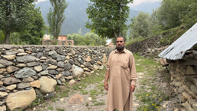 Zulfikar stands in what was once his paddy field, now surrounded by new construction in Ganderbal.