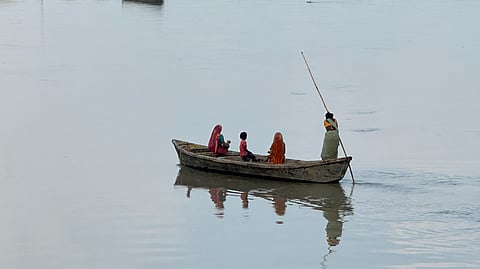 A woman ferrying a boat across the Kosi River in Supaul district. 