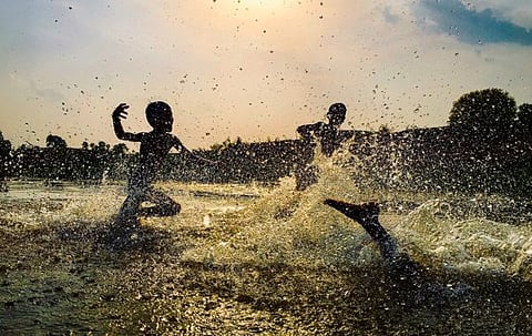 Children splashing water, Adilabad, Telangana  