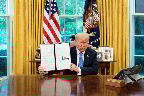 Donald J. Trump displays his signature after signing an Executive Order June 2020