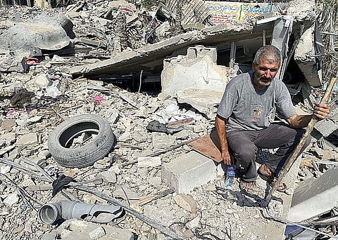 Palestinians inspect the damage following an Israeli airstrike on the El-Remal aera in Gaza City on October 9, 2023.