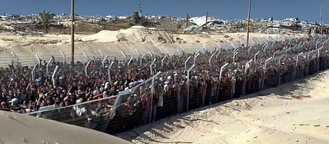 Starving Palestinians push through packed crowds seeking Israeli-US aid.