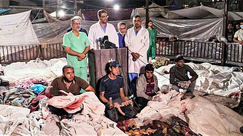 A still from a video depicts doctors delivering a press statement surrounded by the lifeless bodies of victims from the Israeli attack on Al-Ahli Baptist Hospital, October 17, 2023.
