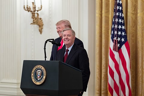 President Donald J. Trump listens and Senator Lindsey Graham
