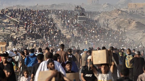 A mass exodus of people from Gaza, carrying belongings, amid a humanitarian crisis worsened by over 19 months of ongoing genocide.