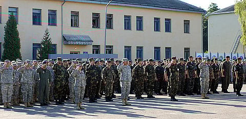 Service members from California Army National Guard and Ukraine present arms for the playing of the American and Ukrainian anthems during the Rapid Trident opening ceremony.