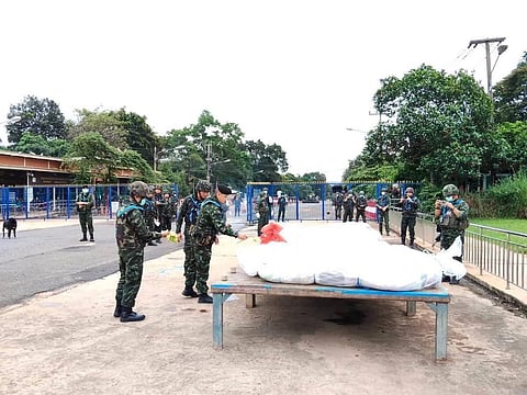 Thai military personnel handing over the bodies of 12 Cambodian soldiers killed in a recent border clash.