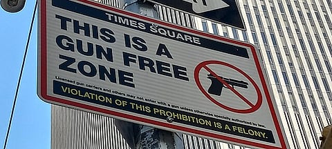 Times Square Gun Free Zone sign on 6th Avenue in Midtown Manhattan.