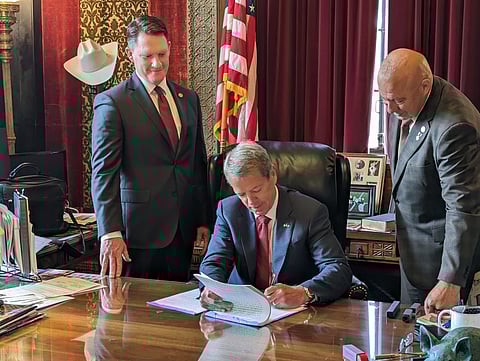 
Governor Jim Pillen signs Legislative Bill 514 in his office, implementing photographic voter identification in Nebraska, as Senators Ben Hansen and Tom Brewer look on, June 2023.