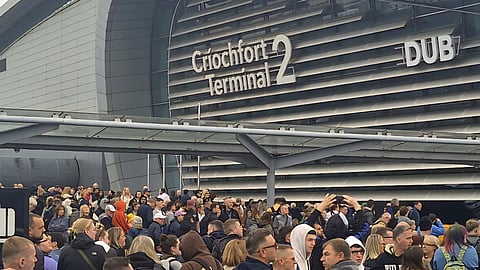 People queue outside Terminal 2 at Dublin Airport.