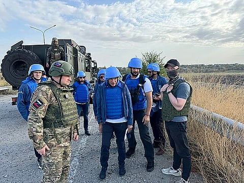  IAEA Experts escorted by Russian soldiers at the frontline crossing near Zaporizhzhya Nuclear Power Plant 