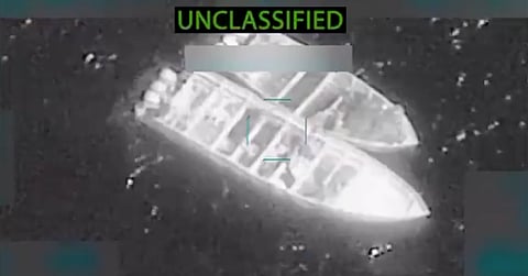 Nighttime drone surveillance of the operations, showing illuminated boats.