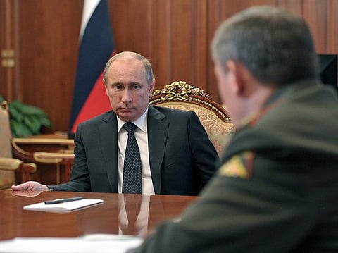 President Vladimir Putin speaks with military chief Valery Gerasimov