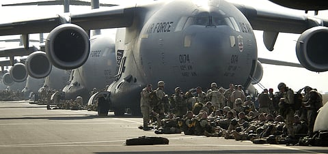U.S. Army paratroopers prepare to board a C-17 Globemaster III. 