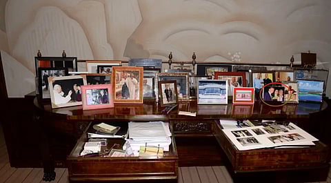 Photo of framed pictures on Epstein's desk—including one of Trump—which was initially removed, sparking cover-up claims amid calls for full transparency and prosecutions.