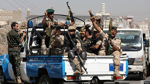 Houthi troops ride on the back of a police patrol truck, February 19, 2020.