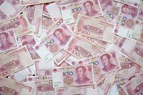 Chinese banknotes stacked together, showcasing multiple one-hundred yuan notes on a flat surface.