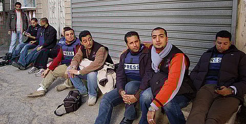 Al Jazeera's Gaza crew and other journalists out on the street following concerns that their media building could be hit by the military.