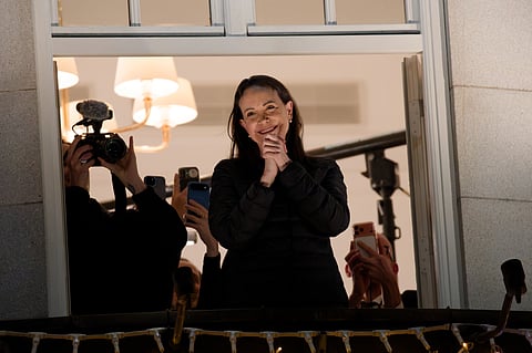 María Corina Machado on the front balcony of the Grand Hotel in Oslo, greeting a crowd that had gathered to see her during Nobel Week 2025.