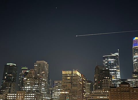 Atmospheric reentry of SpaceX's Crew Dragon capsule carrying NASA's Crew-11 over San Francisco's skyline.